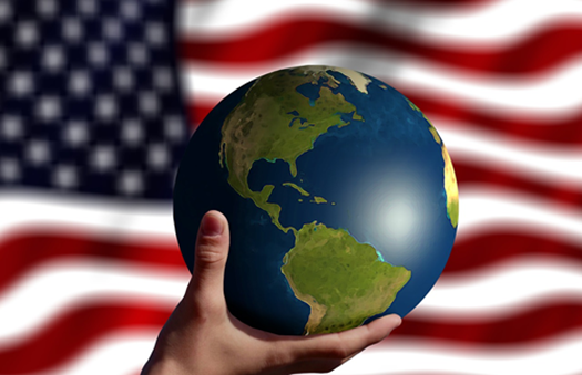Earth in hand with USA flag in background.